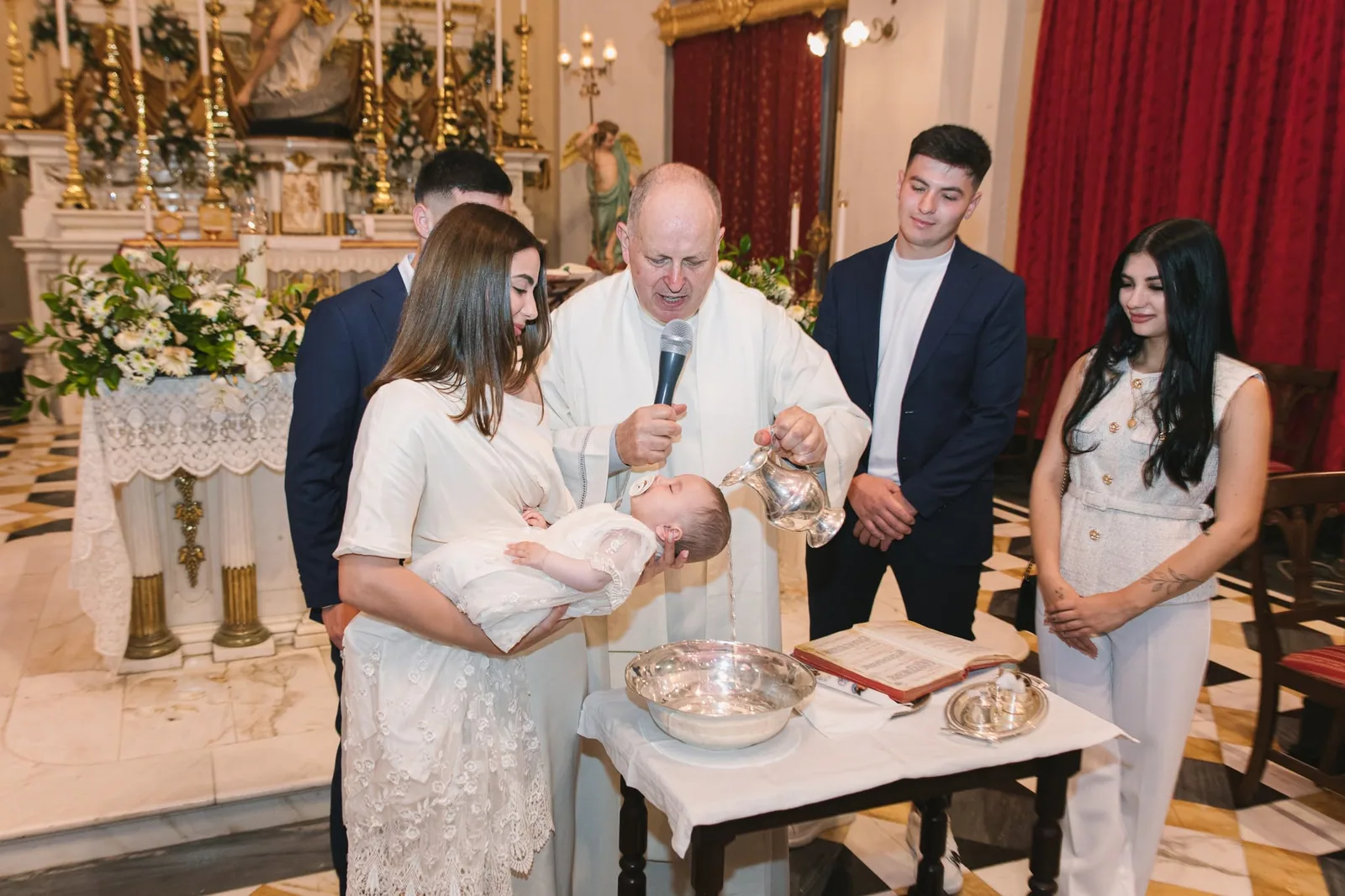 baby baptism with family at altar malta