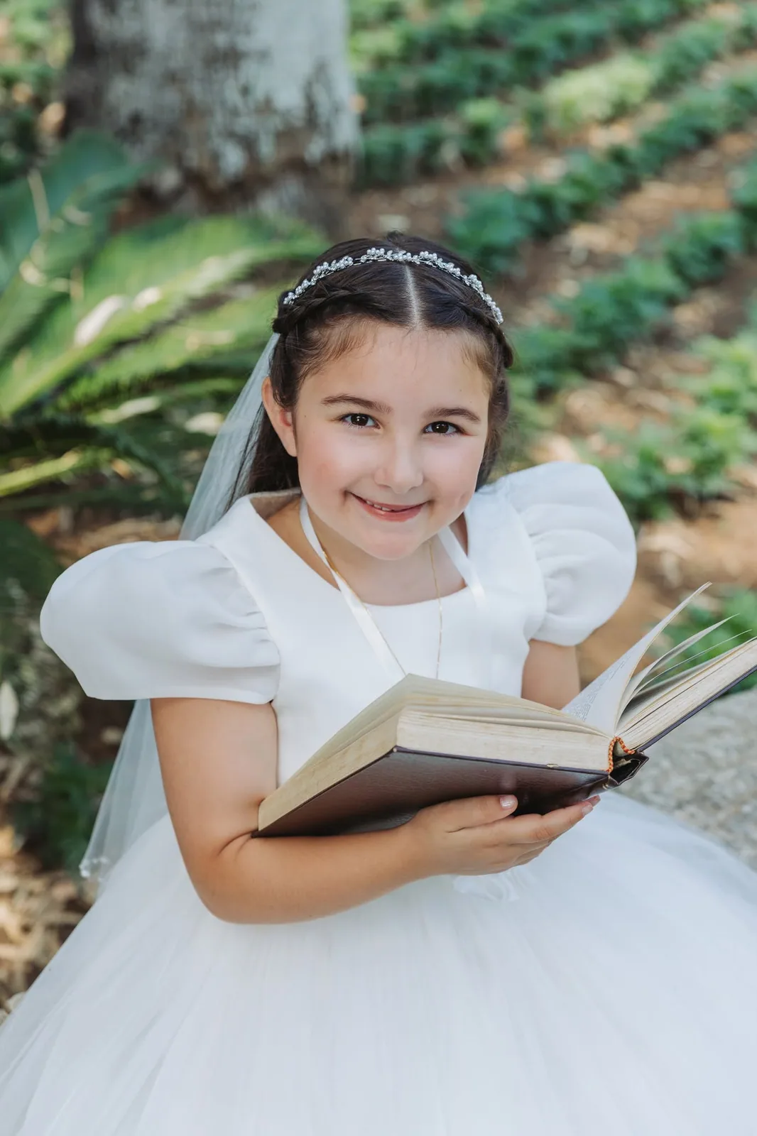 first communion girl reading in garden malta