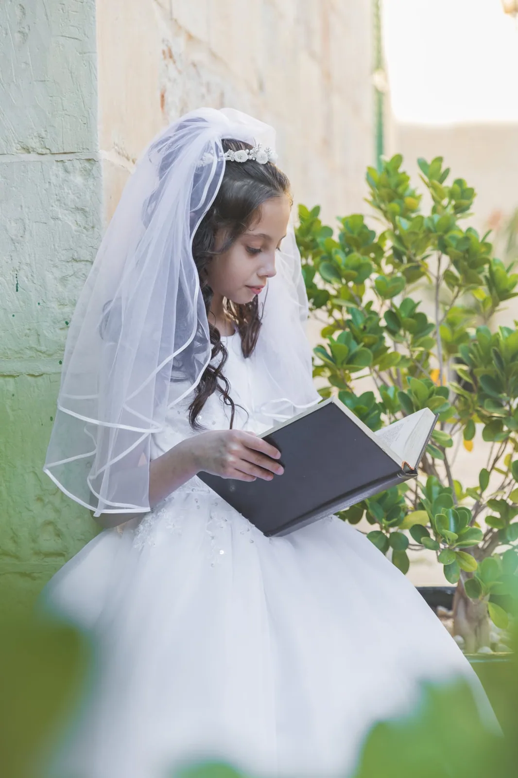 first communion girl reading prayer book malta
