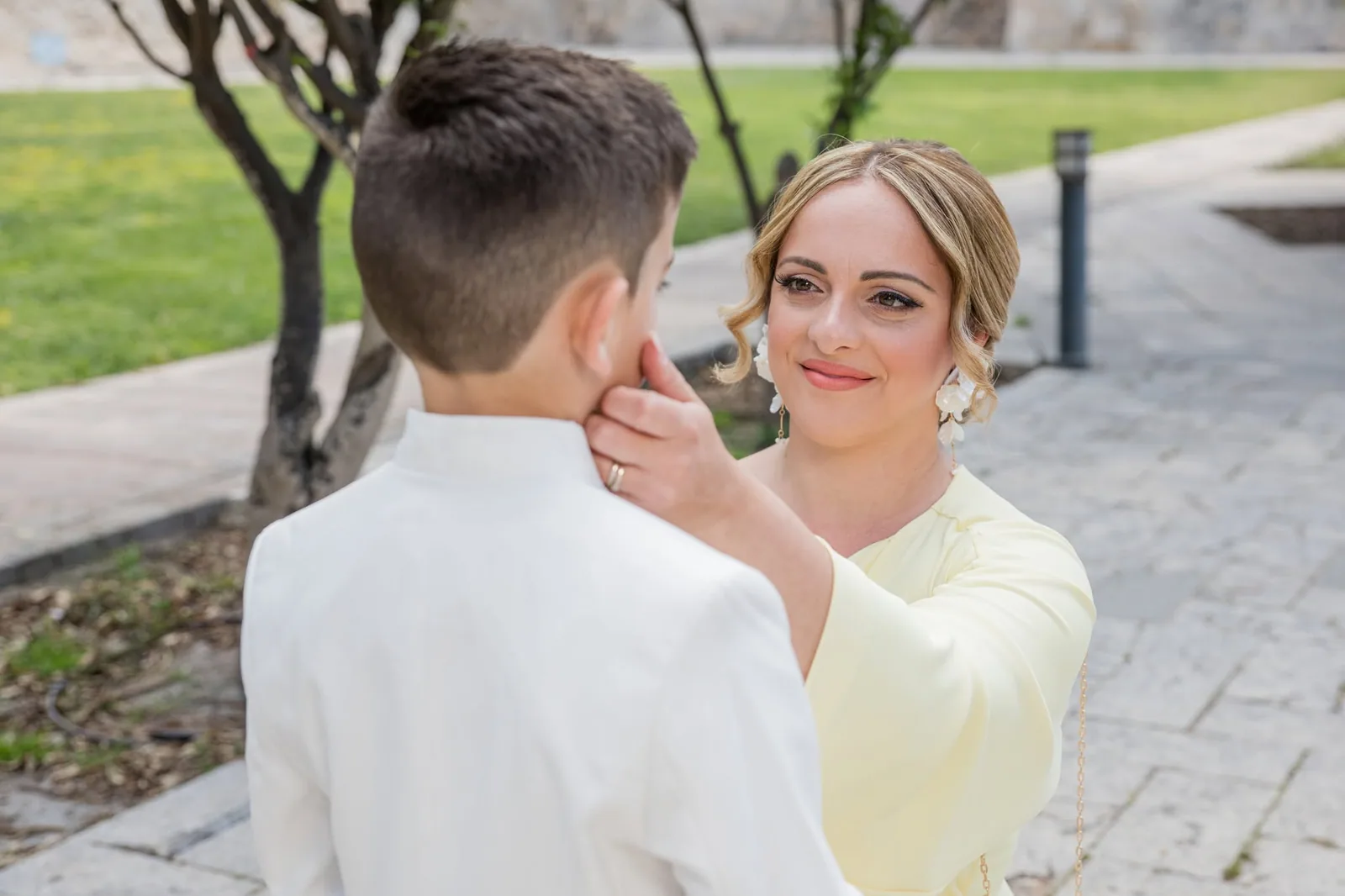 mother adjusting sons communion outfit malta