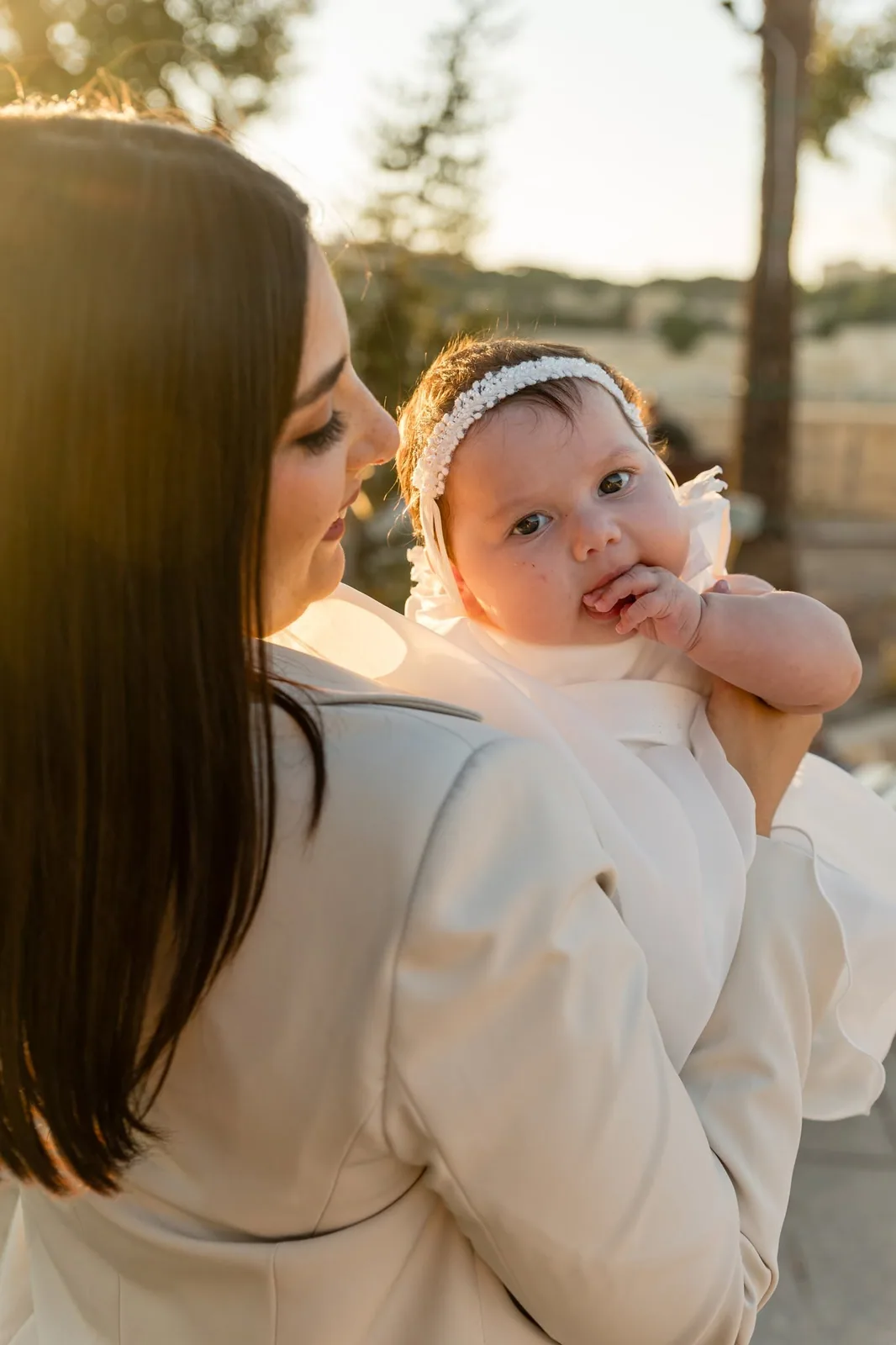 mother holding baby at sunset malta