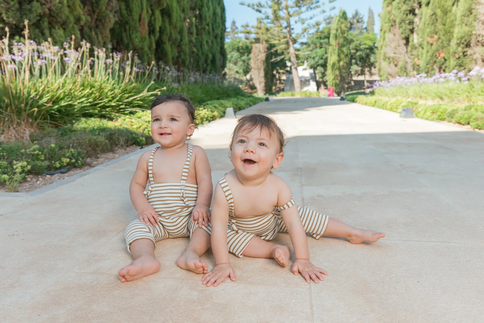 two babies laughing on garden path malta