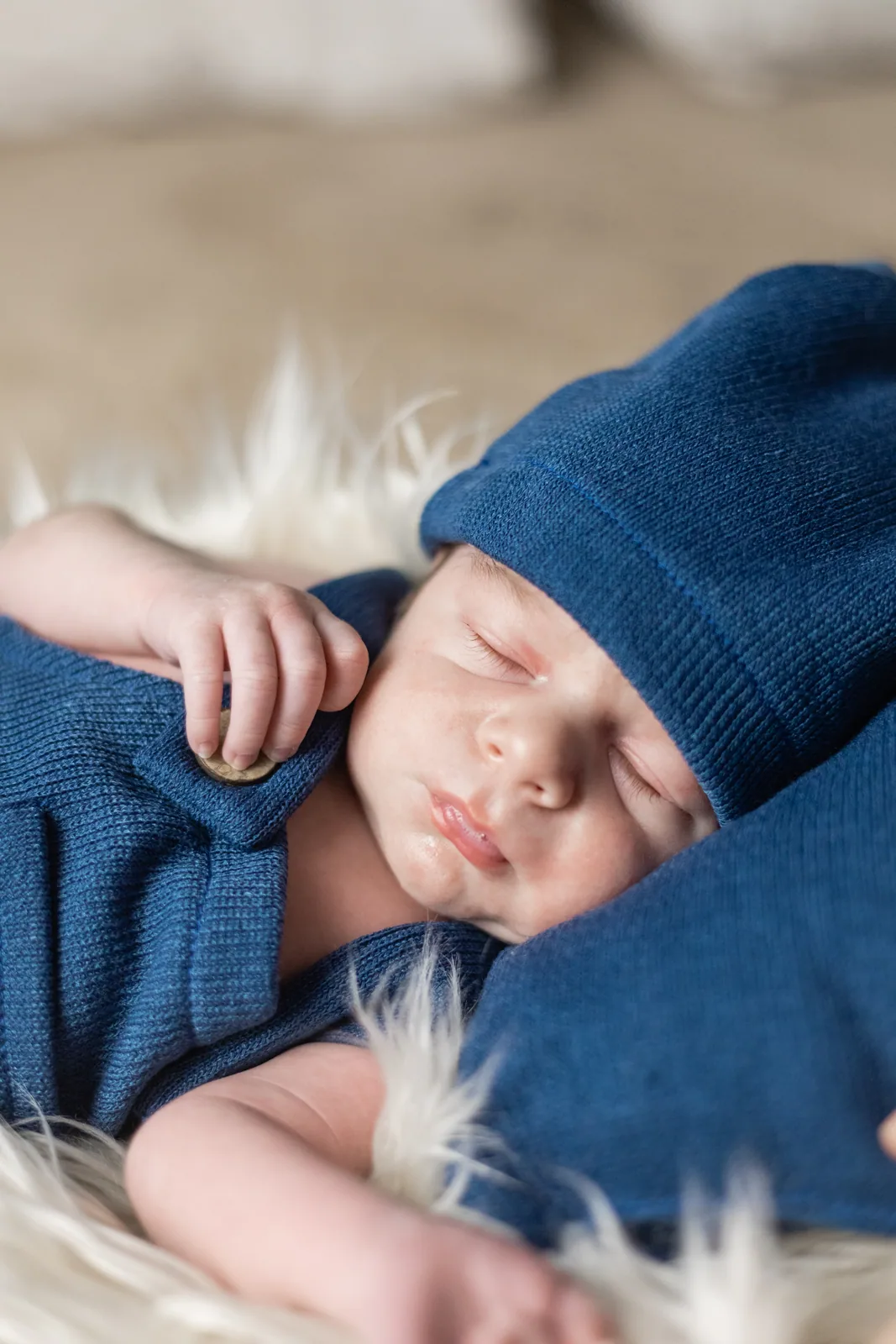 newborn resting in blue outfit malta