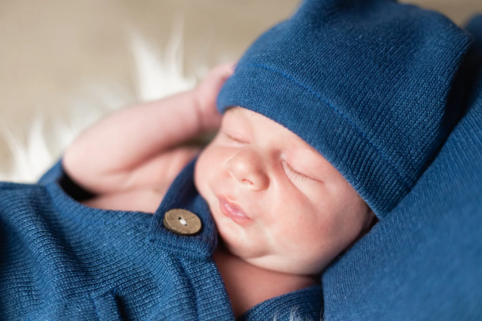 sleeping newborn in blue knitted hat malta