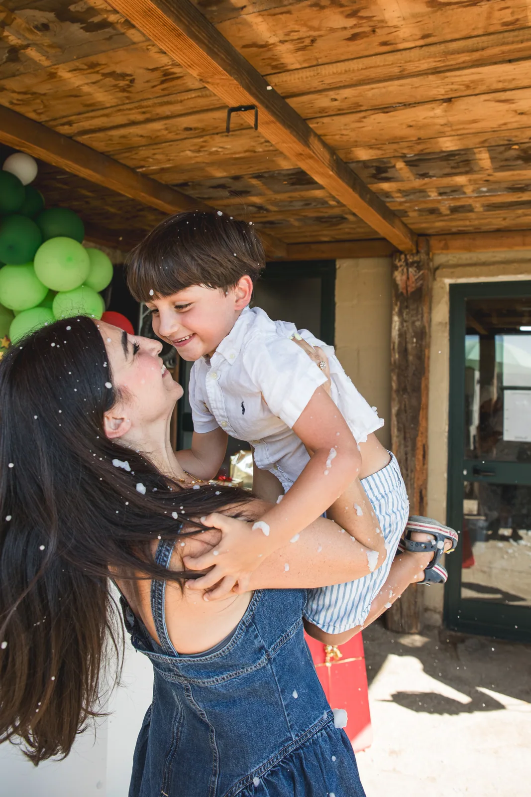 woman lifting boy at birthday party malta