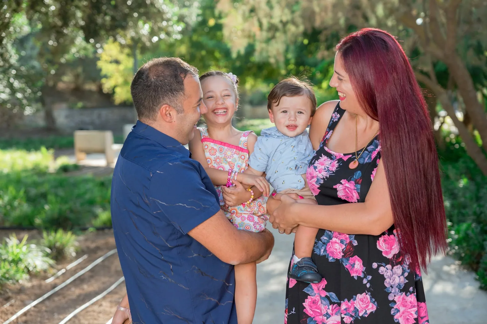 family of four laughing in garden malta