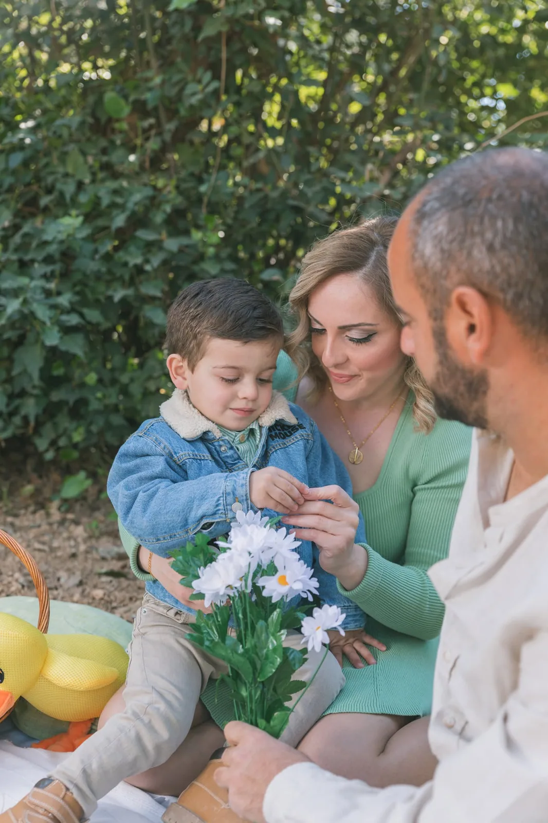 family playing with toddler and flowers malta