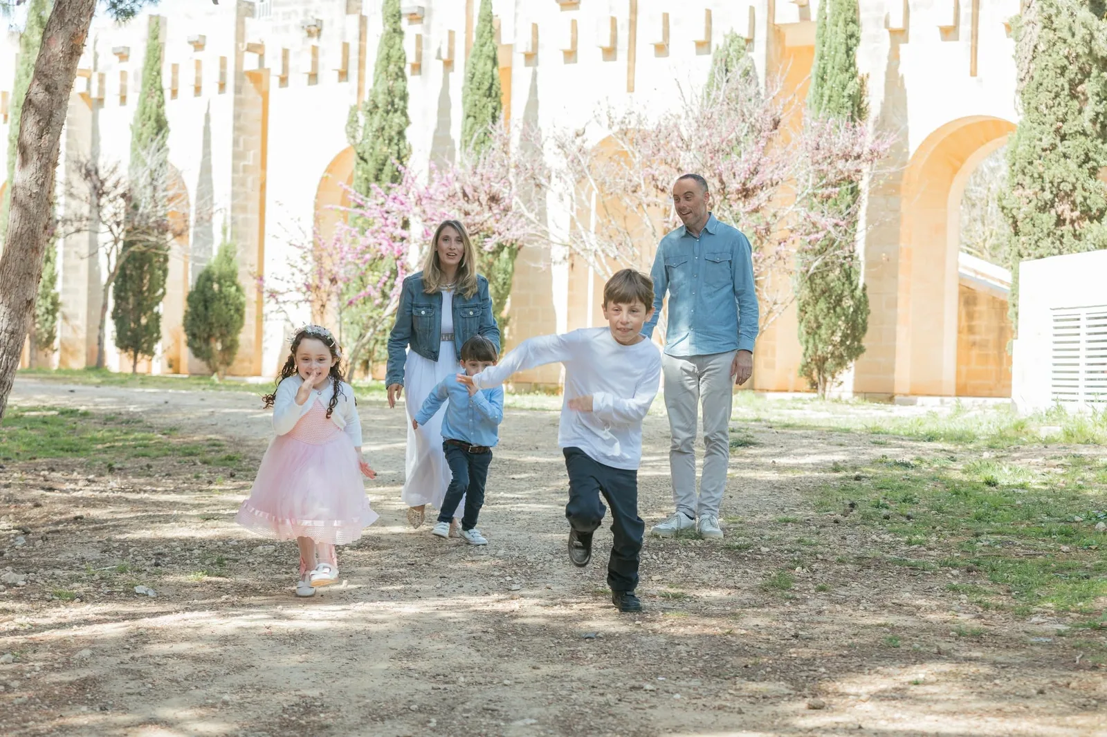 family running together through garden malta