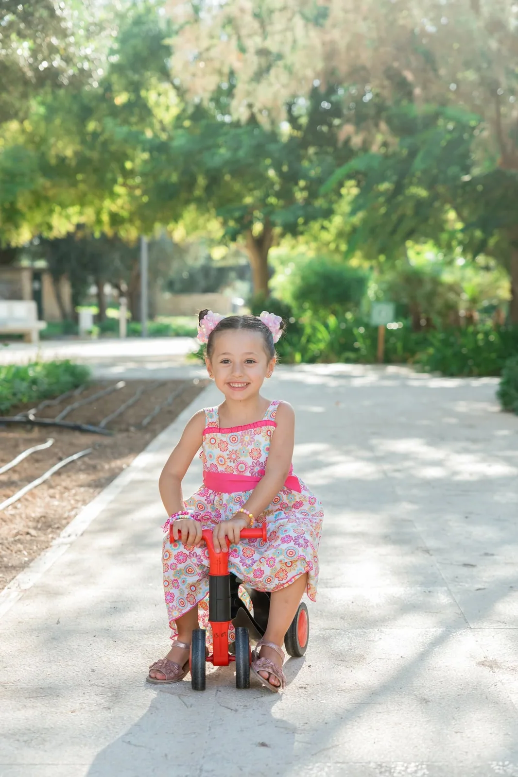 girl riding bicycle on garden path malta