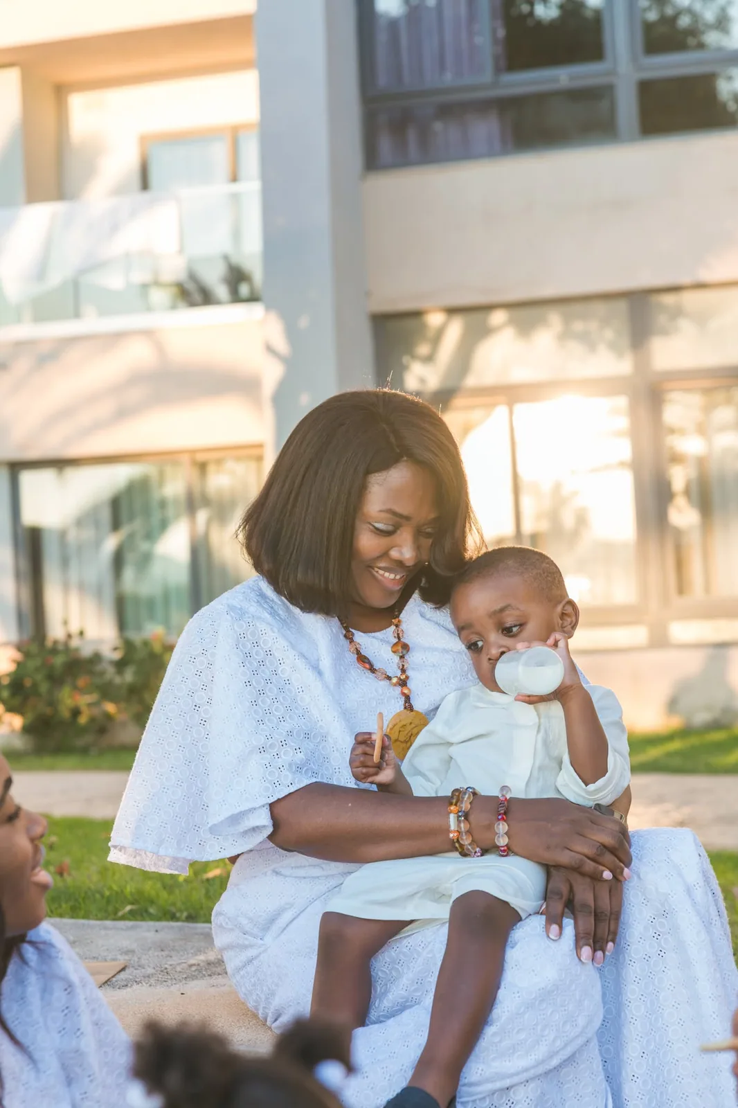 mother cradling baby in white dress malta