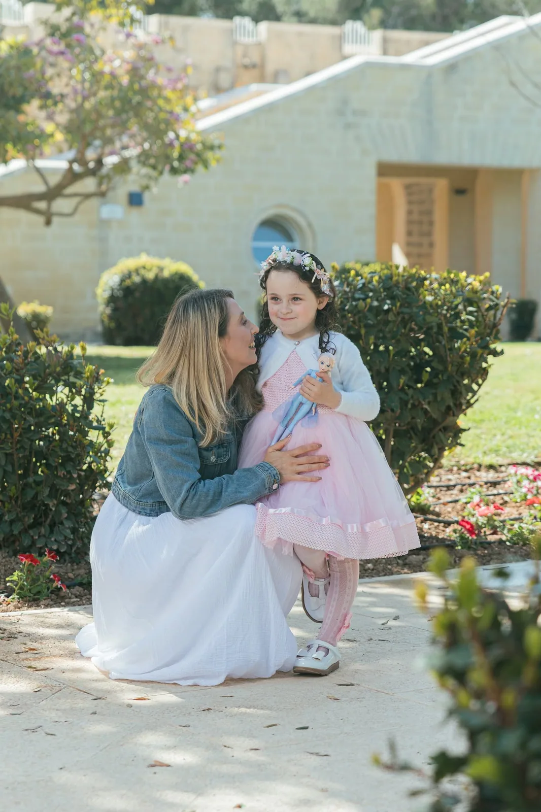 mother kissing daughter in pink dress malta