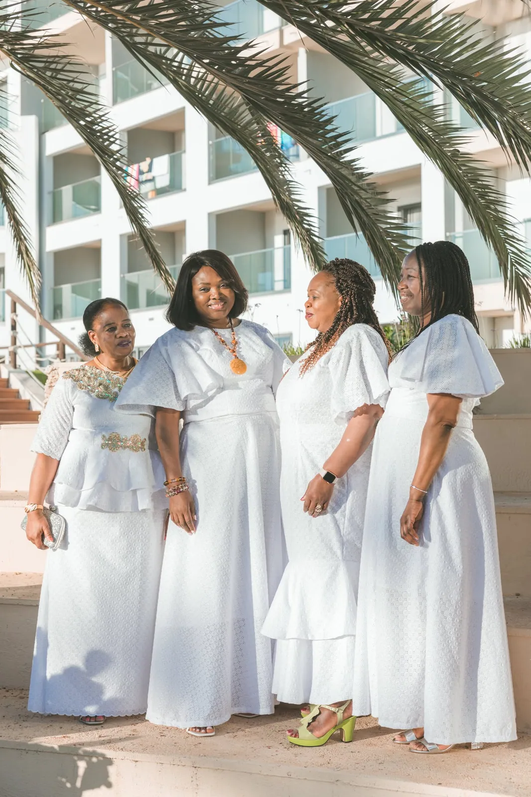 women in white dresses beneath garden pergola malta