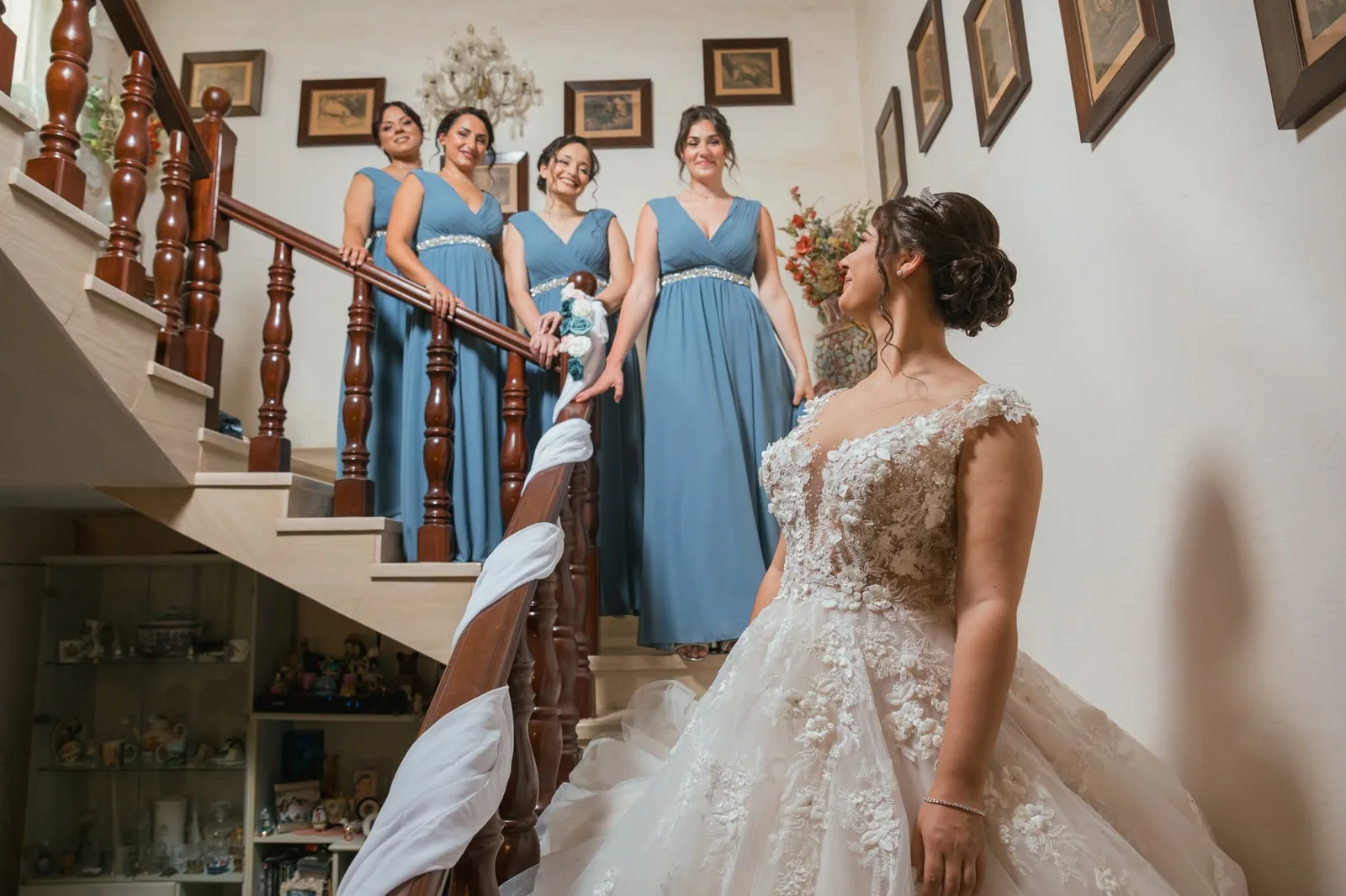 bride and blue dressed bridesmaids on staircase malta