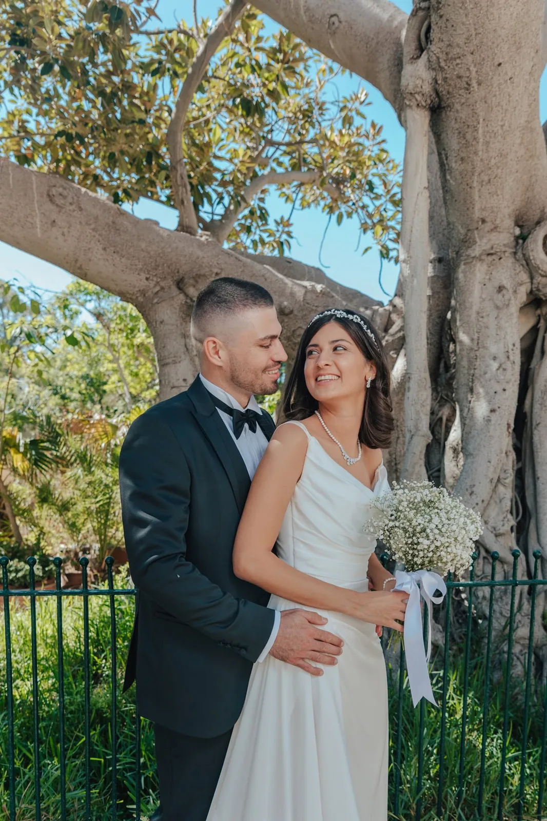 bride and groom embracing beneath tree malta