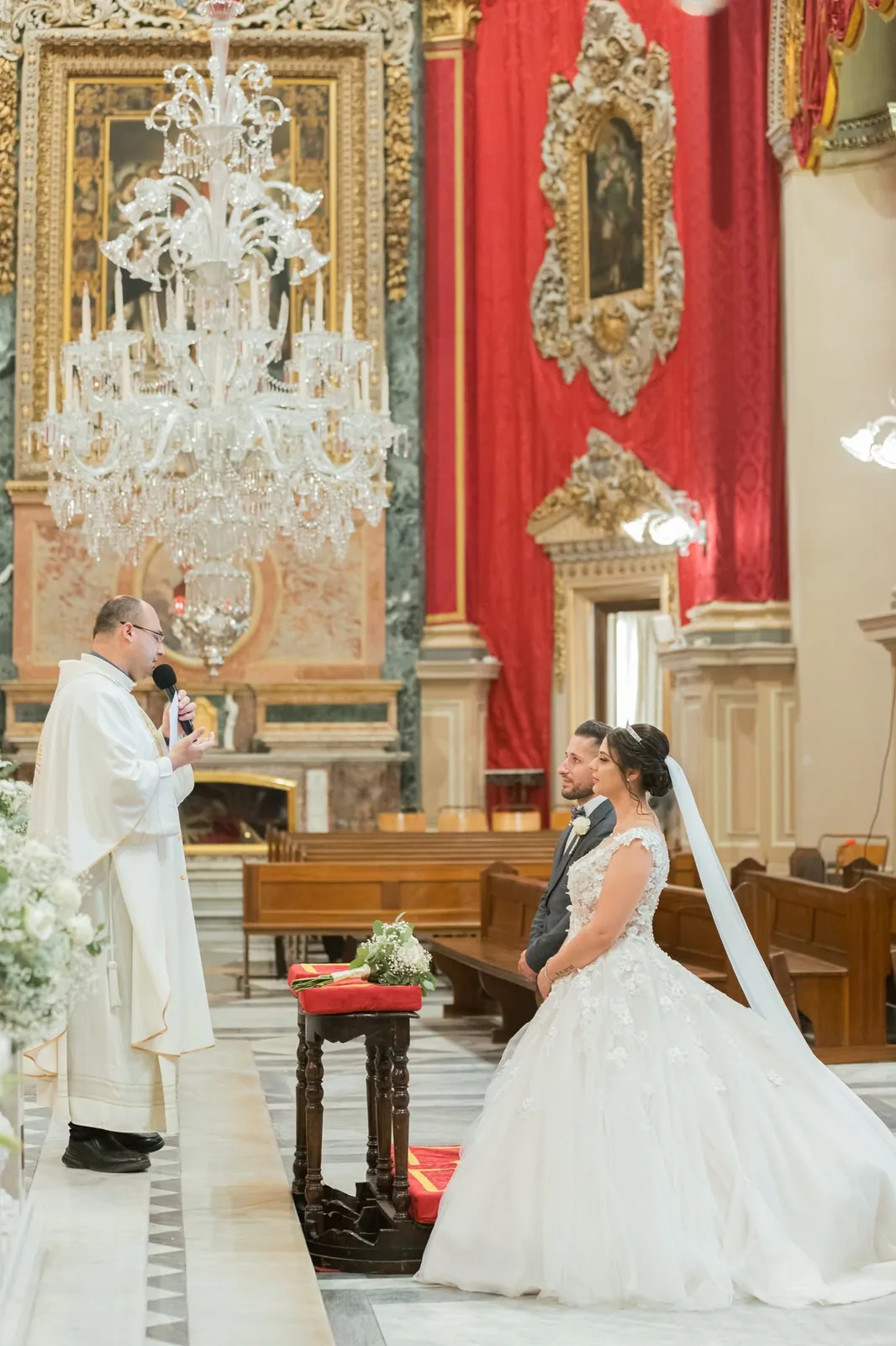 bride and groom exchanging vows at altar malta