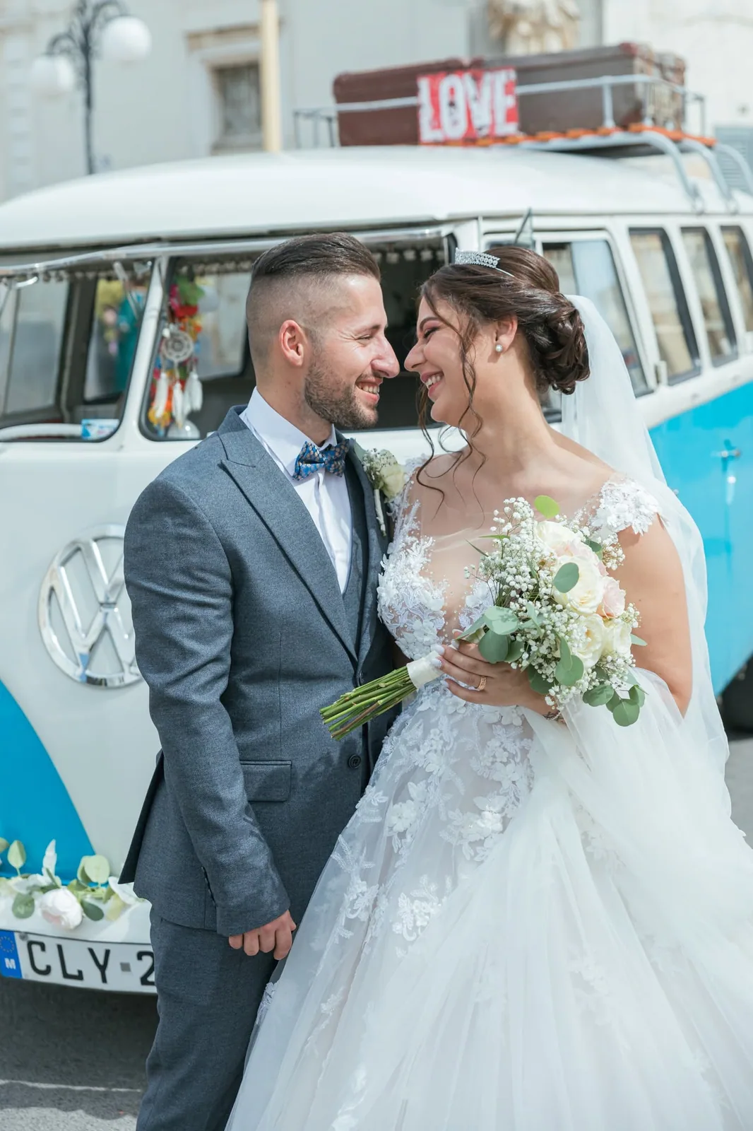 bride and groom kissing beside vintage van malta