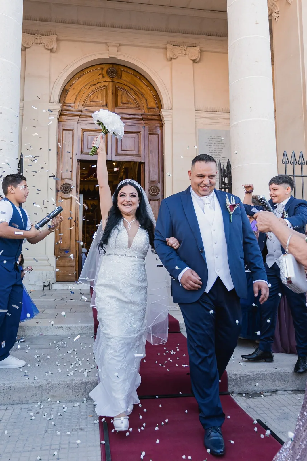 bride and groom leaving church under confetti malta