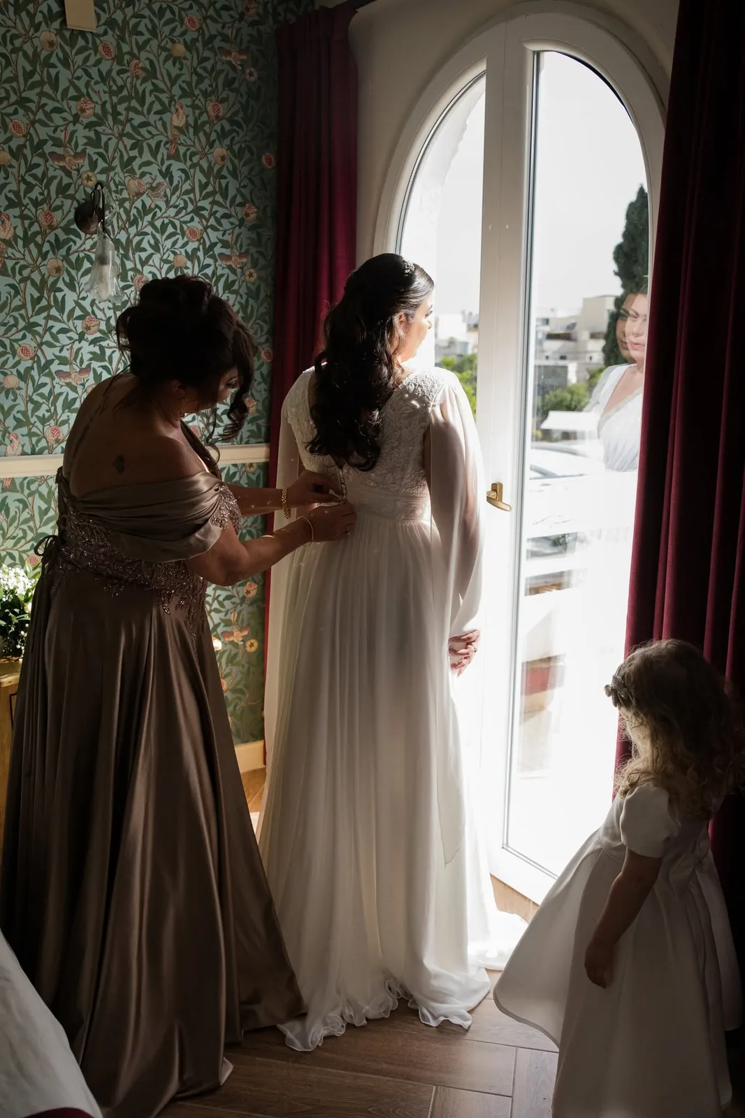 bride getting ready beside open door malta