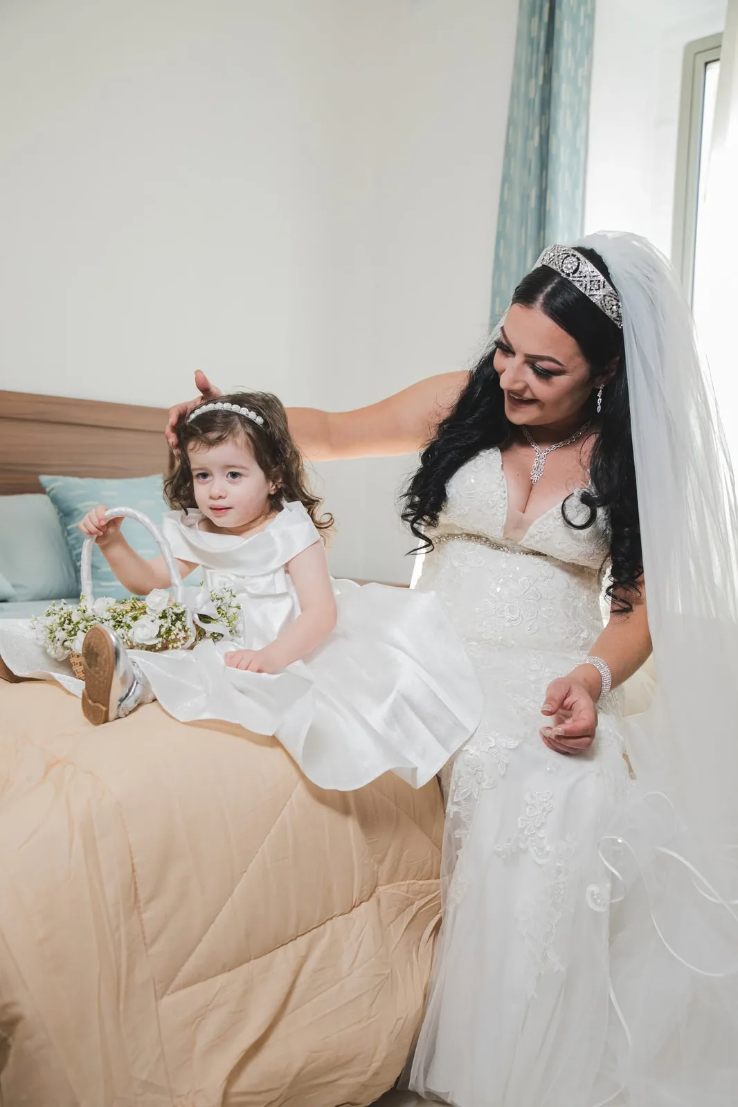 bride helping flower girl on bed malta