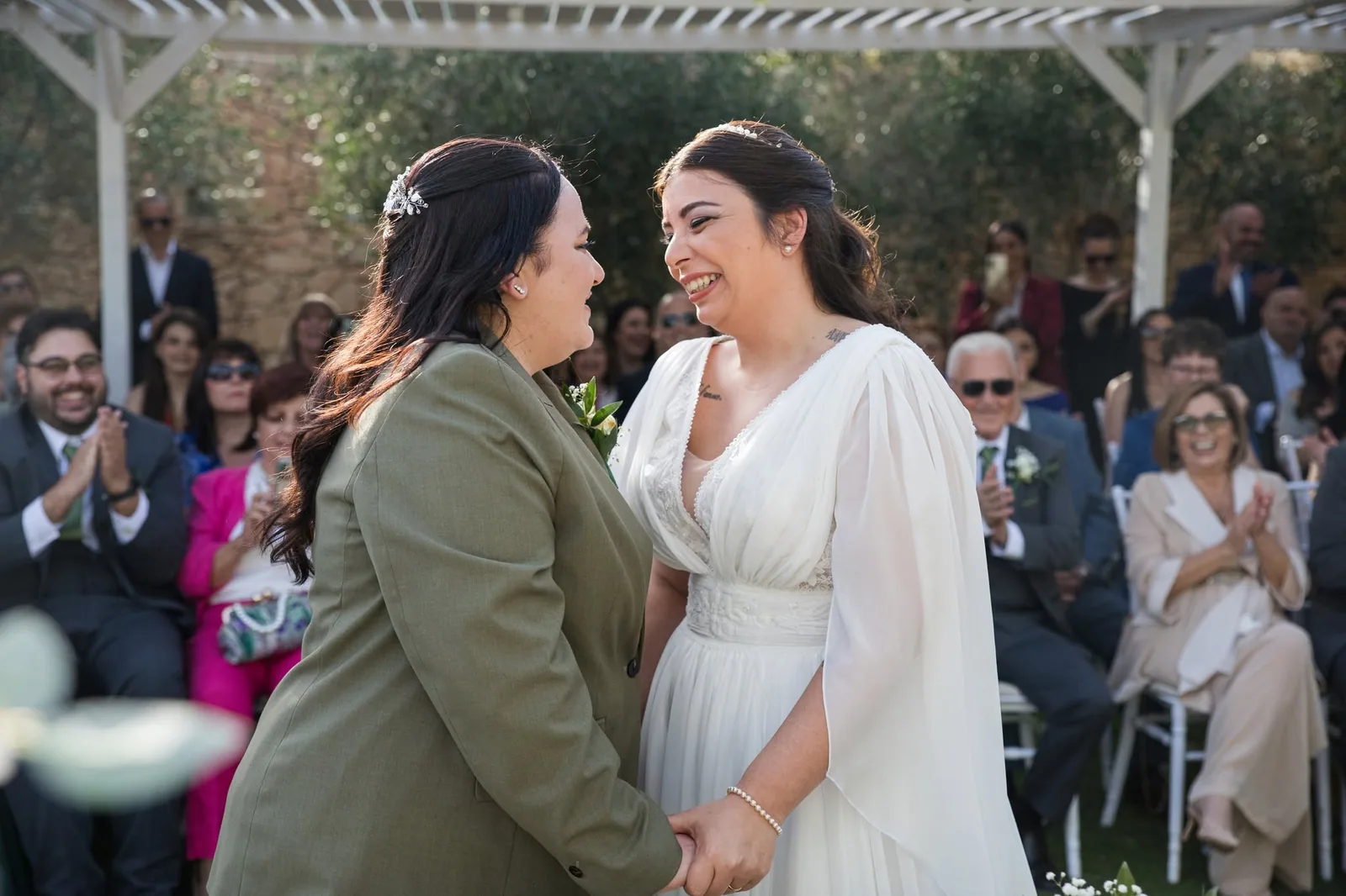 bride holding hands with woman at ceremony malta