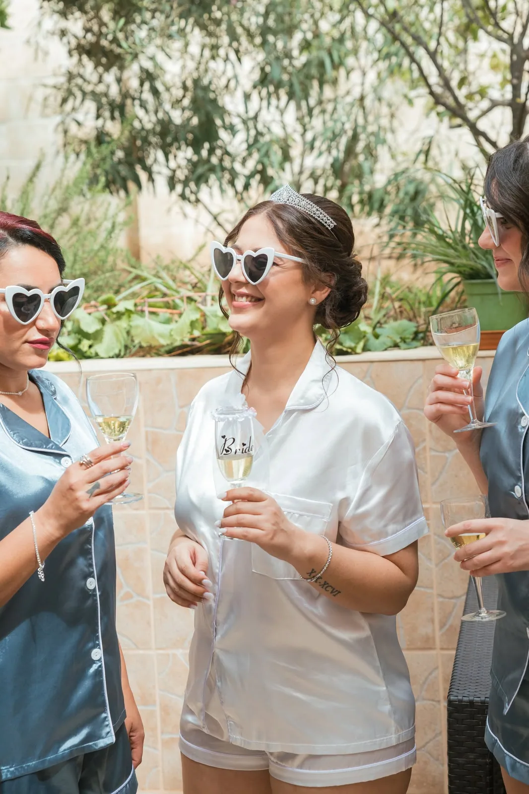 bride in satin pajamas with drink malta