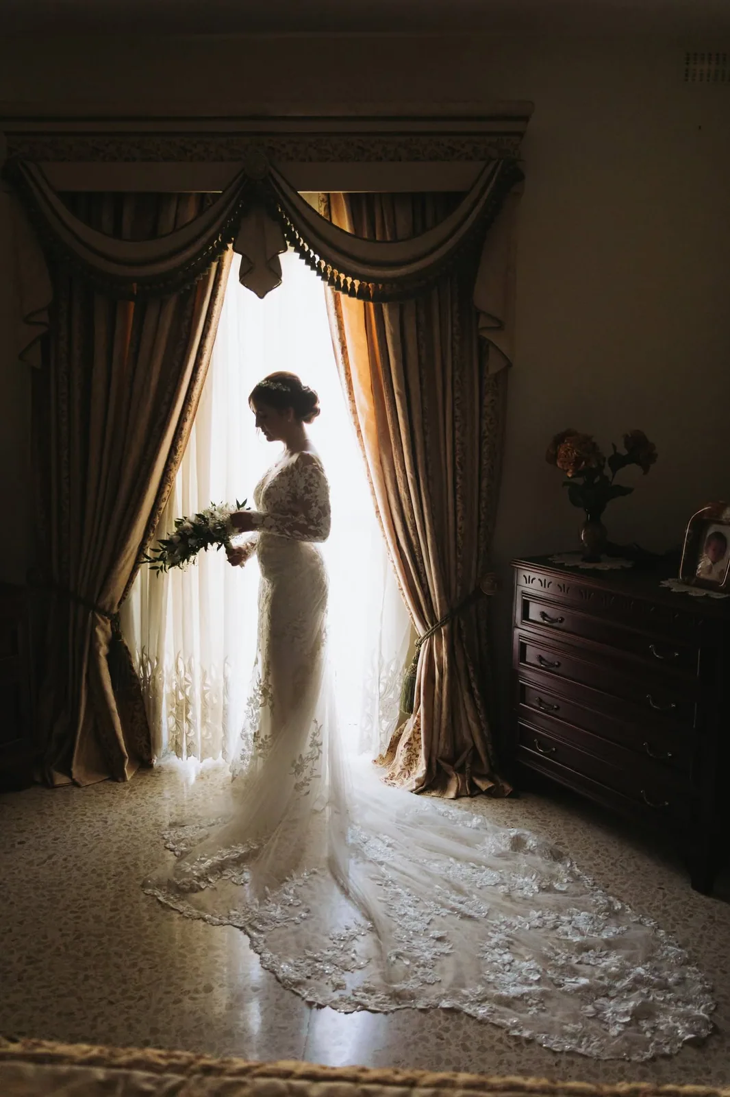 bride silhouette framed by curtains malta