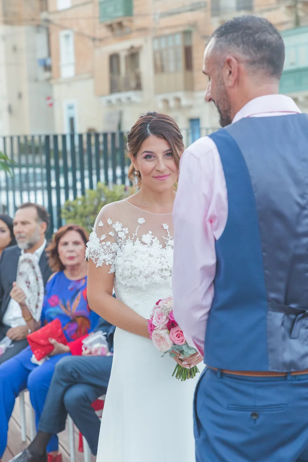 bride smiling at groom during outdoor ceremony malta