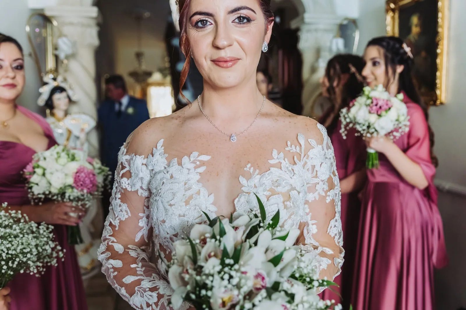 bride with bouquet and burgundy bridesmaids malta