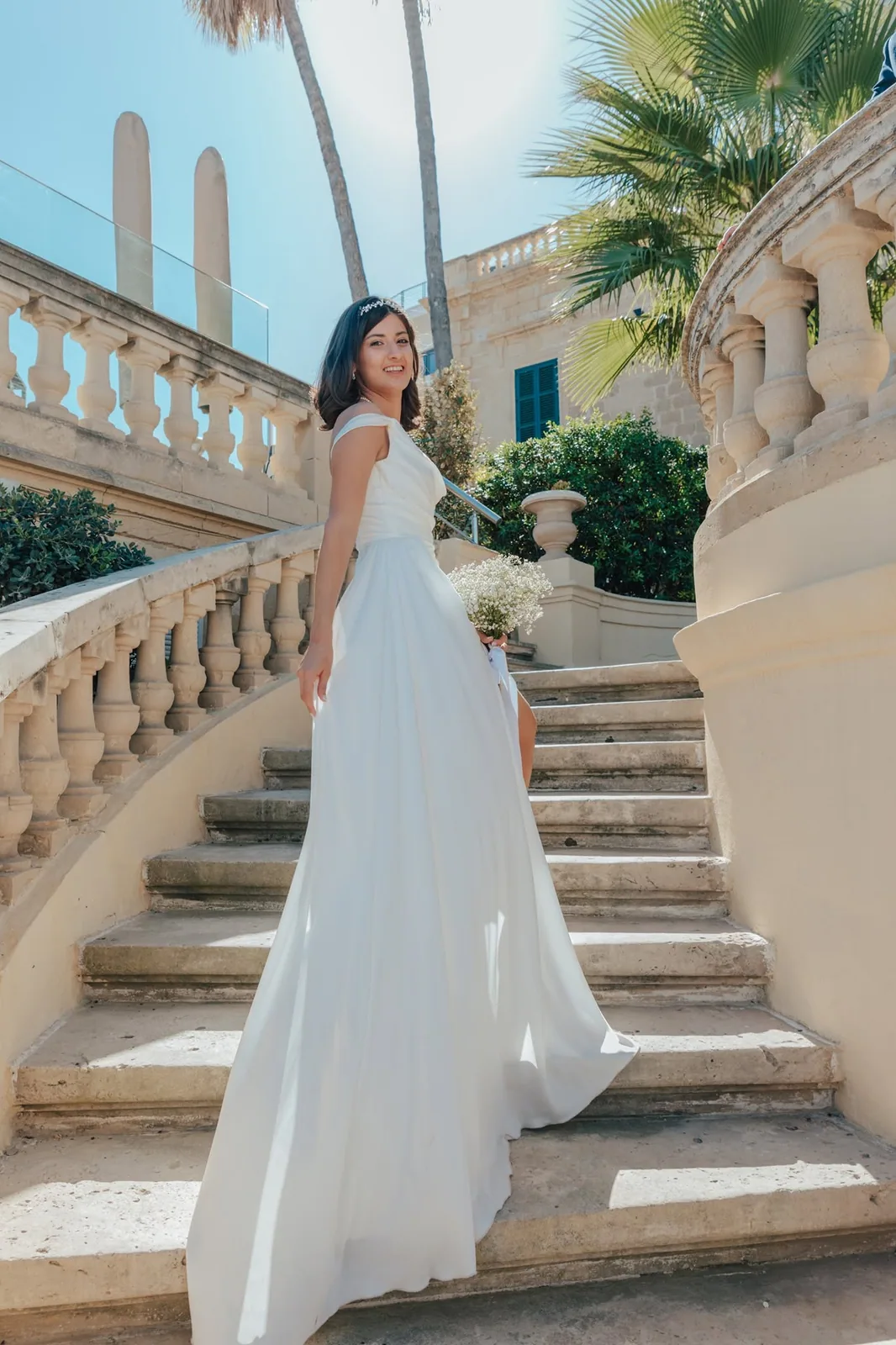 bride with bouquet on stone staircase malta