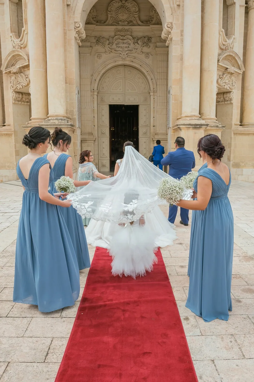 bridesmaids helping bride enter church malta