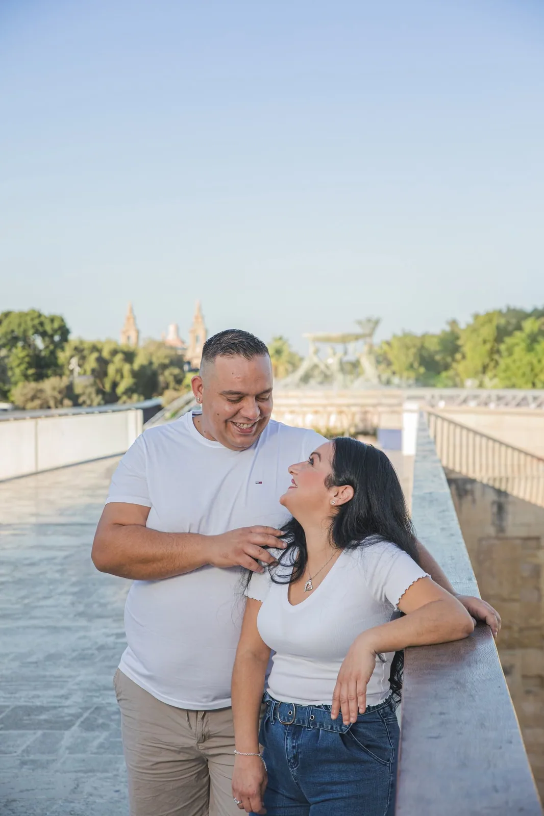 couple laughing beside waterfront railing malta