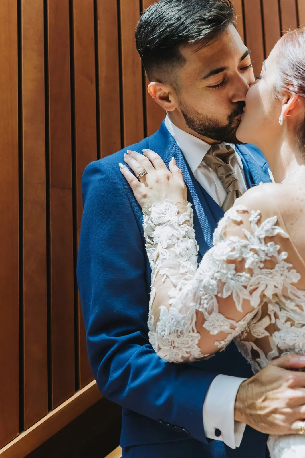 groom kissing bride beside wooden door malta