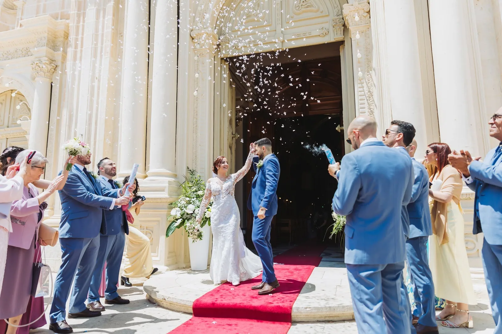 newlyweds celebrating on red carpet outside church malta