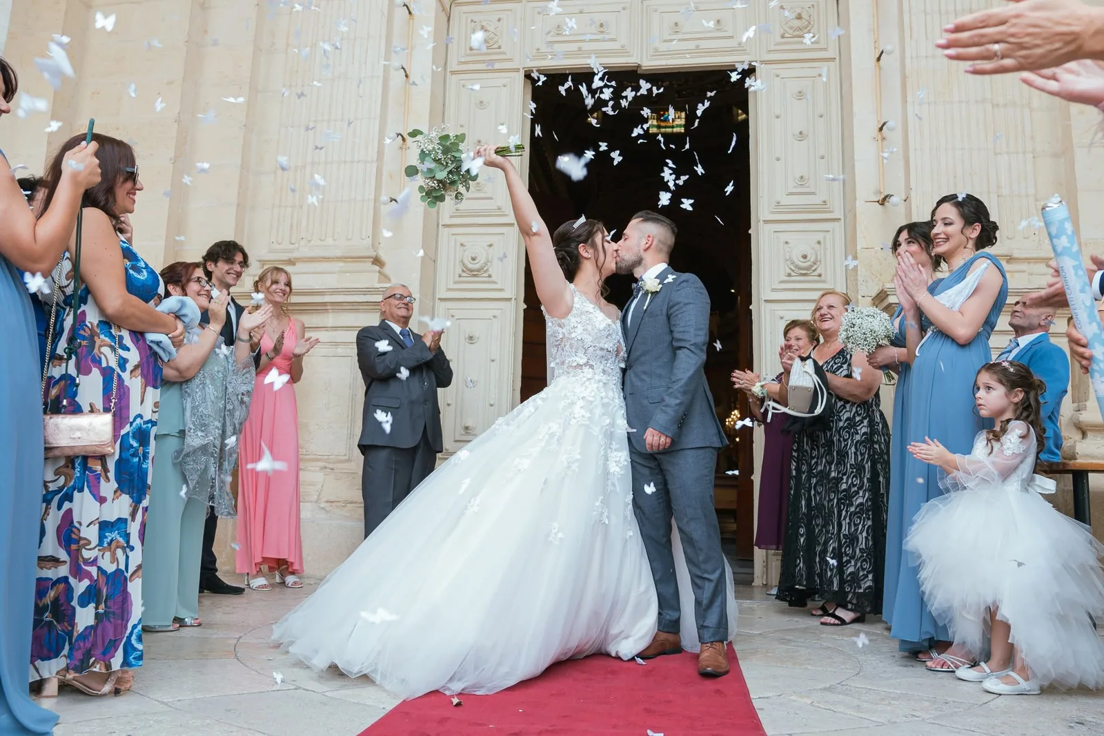 newlyweds kissing under confetti outside church malta