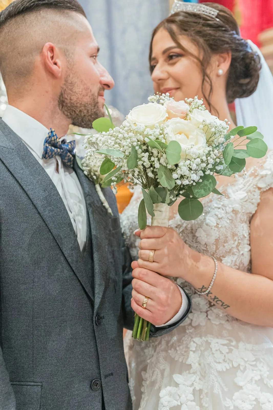 newlyweds smiling with white rose bouquet malta