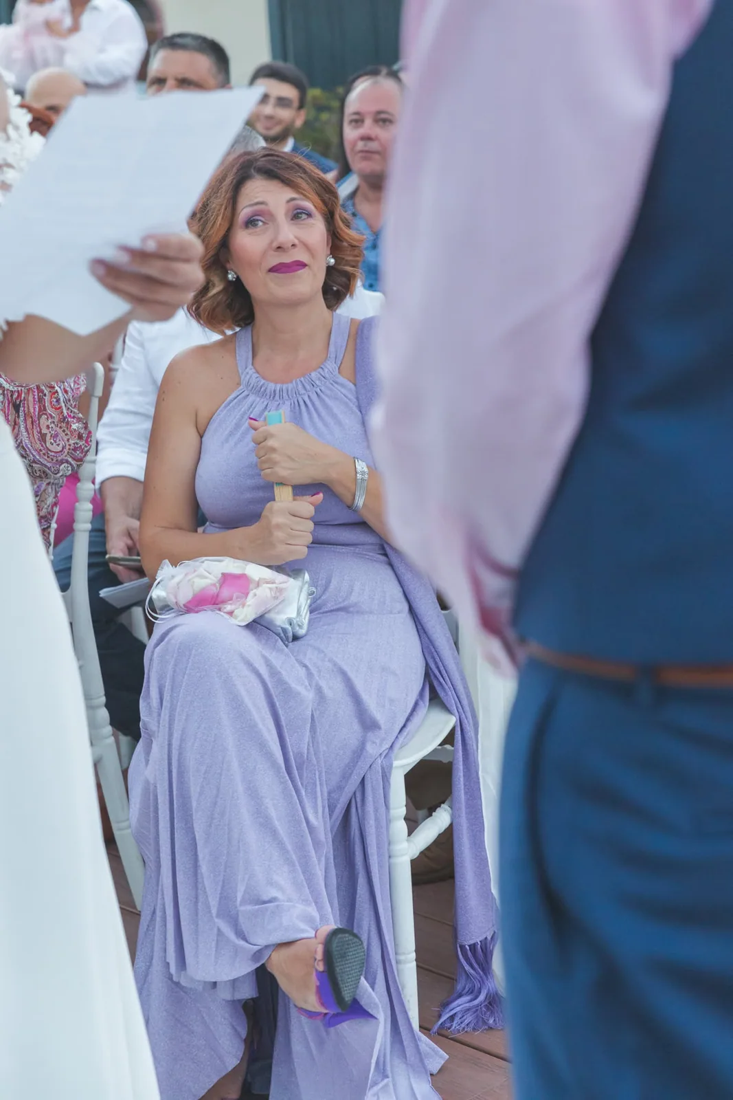 seated woman reading at outdoor wedding ceremony malta