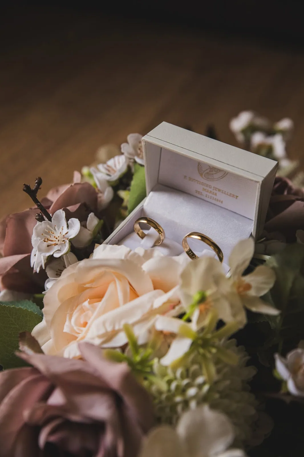 wedding rings in box with rose bouquet malta
