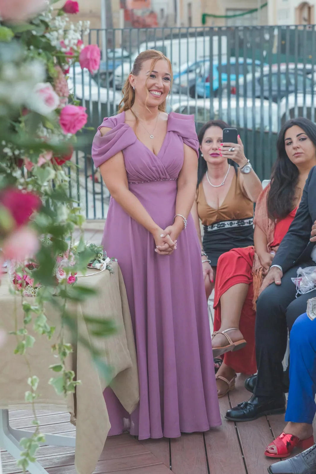 woman in purple dress speaking at wedding ceremony malta